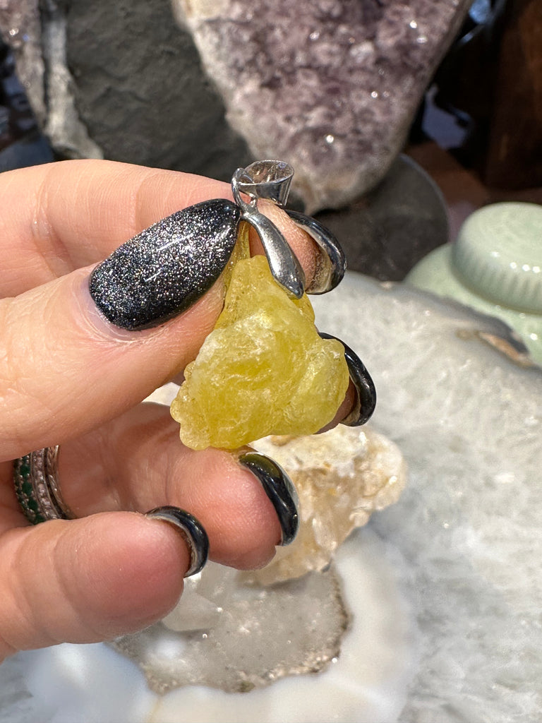Rough yellow brucite gemstone pendant