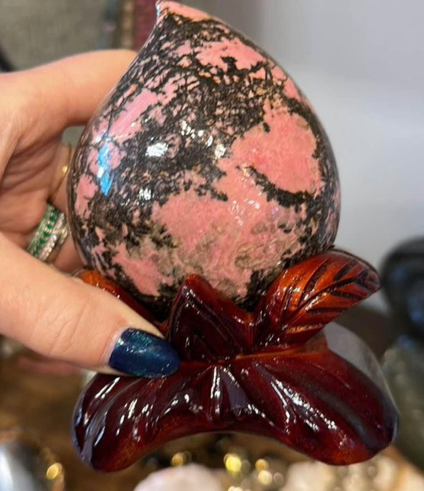 Rhodonite swirl specimen on stand